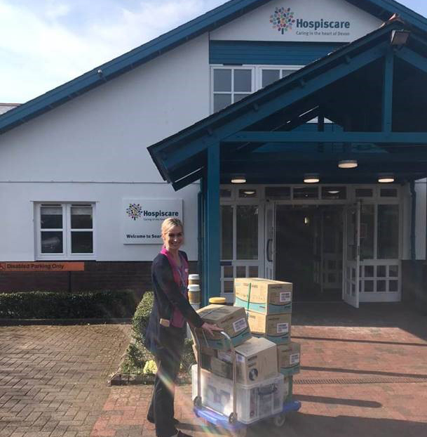 A Hospiscare nurse with boxes of donated PPE