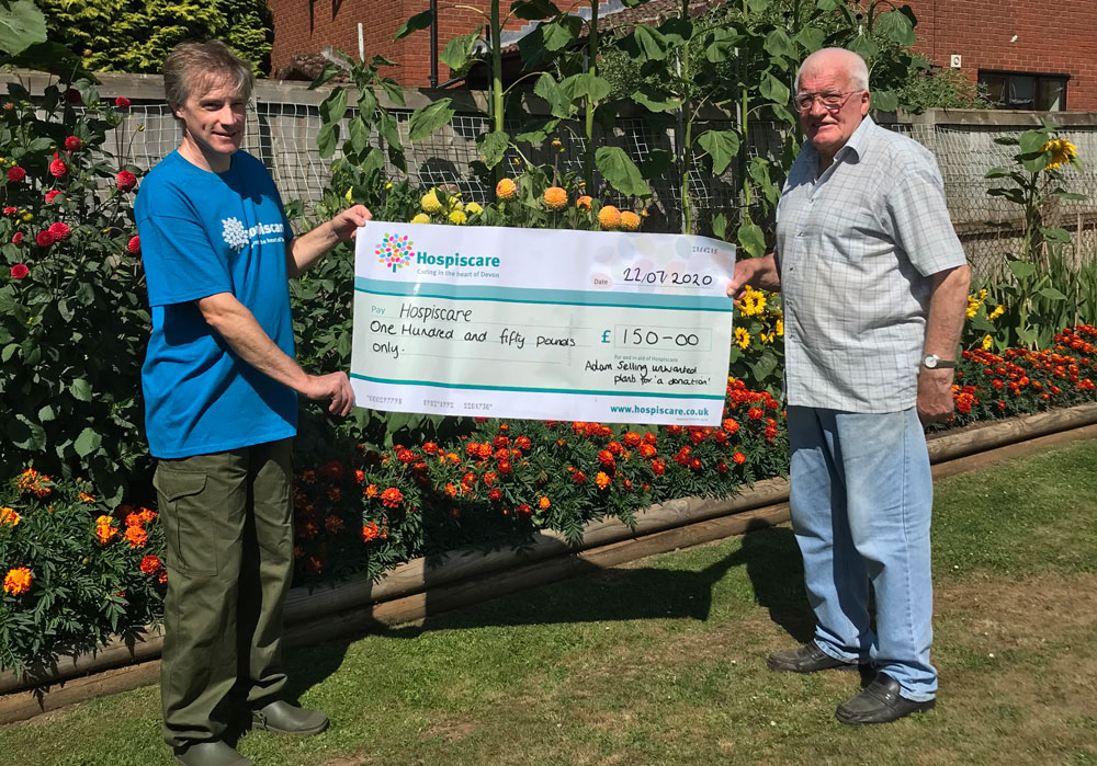 Two men with a Hospiscare cheque