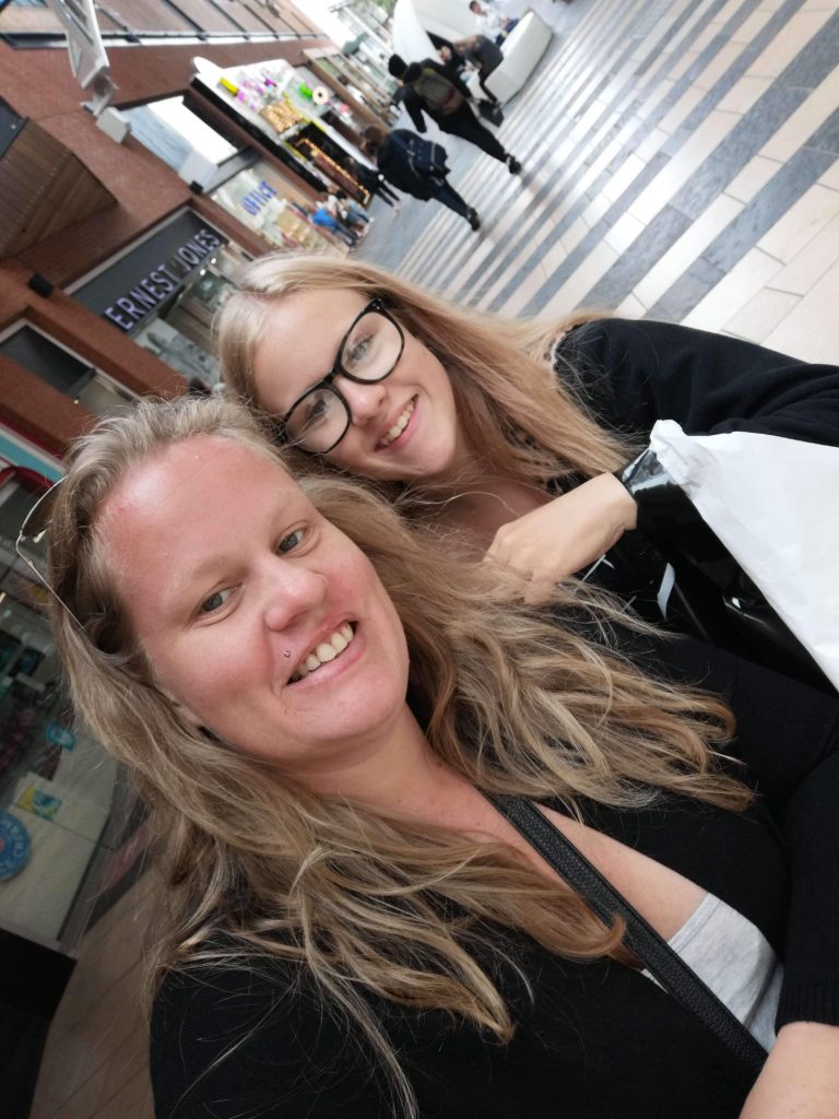 Two women in an outdoor shopping centre