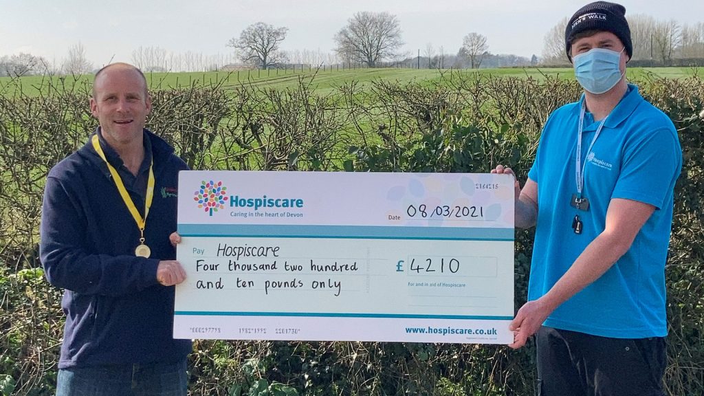 Two men holding a big cheque for Hospiscare