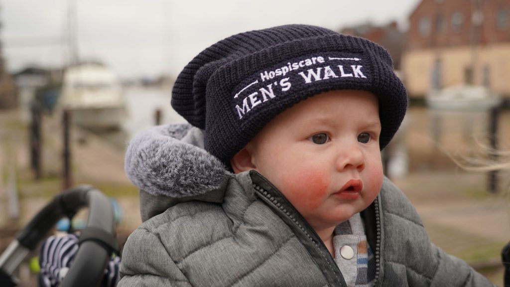 A baby wearing a Men's Walk beanie hat