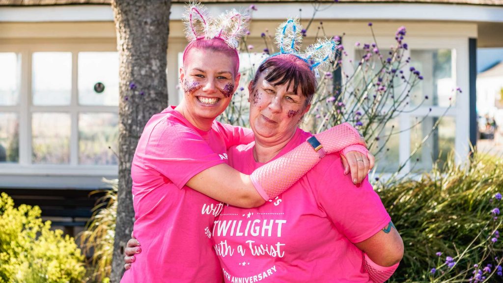 Two women in pink Twilight t-shirts wearing bunny ears