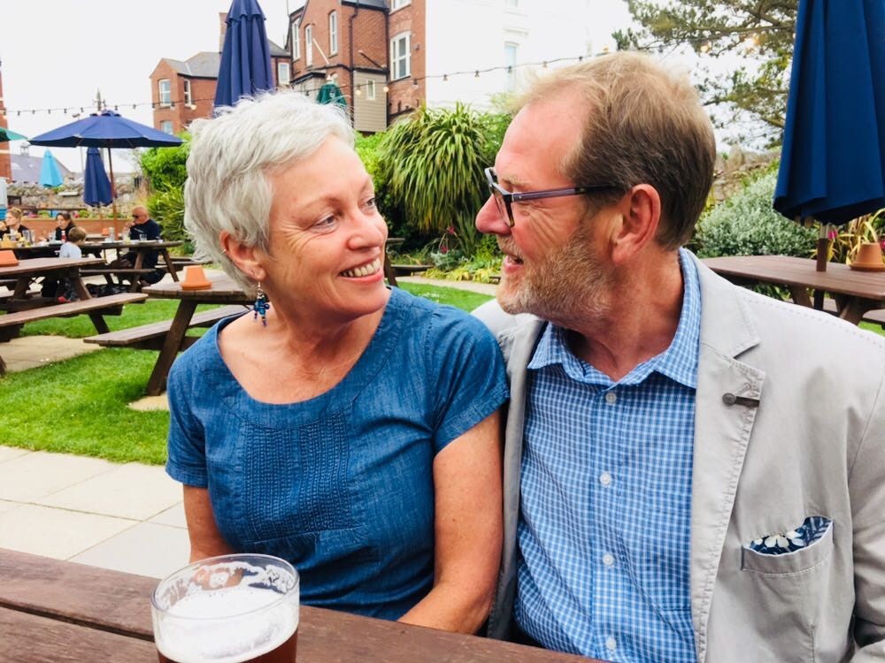 A woman and man sitting in a pub garden