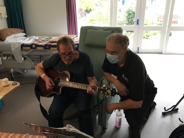 A male patient playing guitar