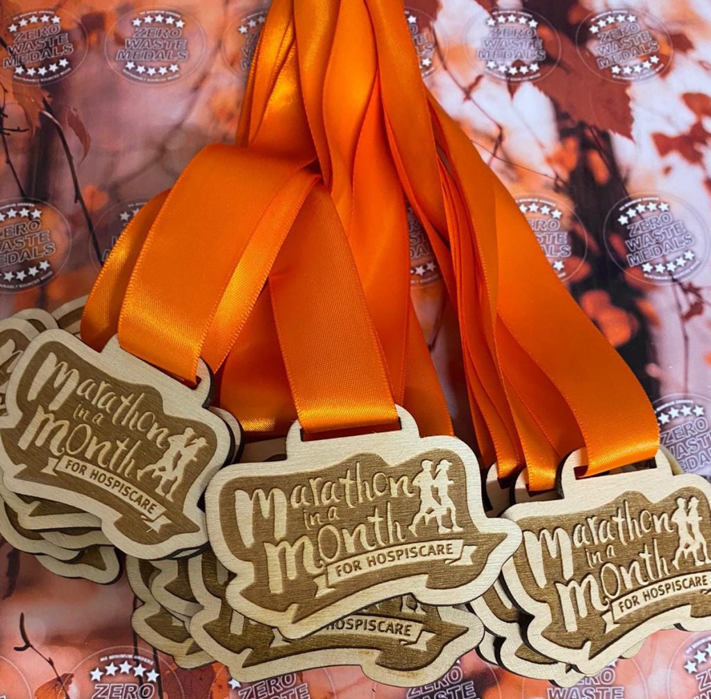 Marathon in a Month medals with orange ribbons