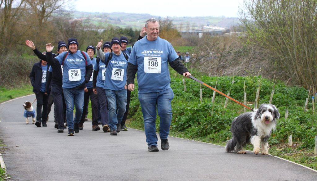 A man and his dog taking part in a sponsored walk