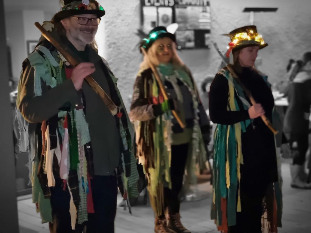 A group of Morris Dancers in green rags
