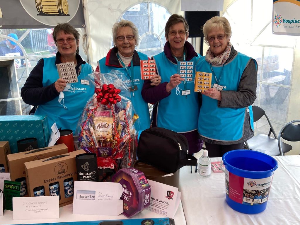A group of women behind a raffle table