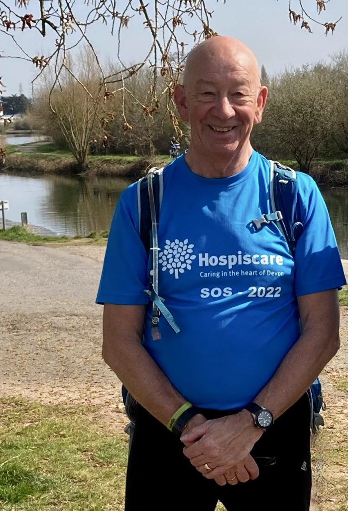A man wearing a Hospiscare t-shirt outside