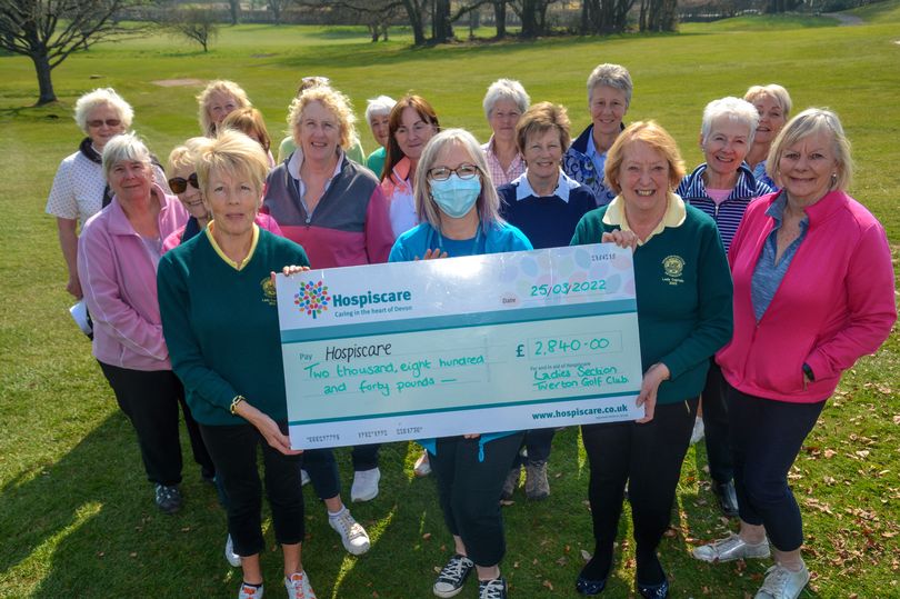 A group of women holding a giant cheque