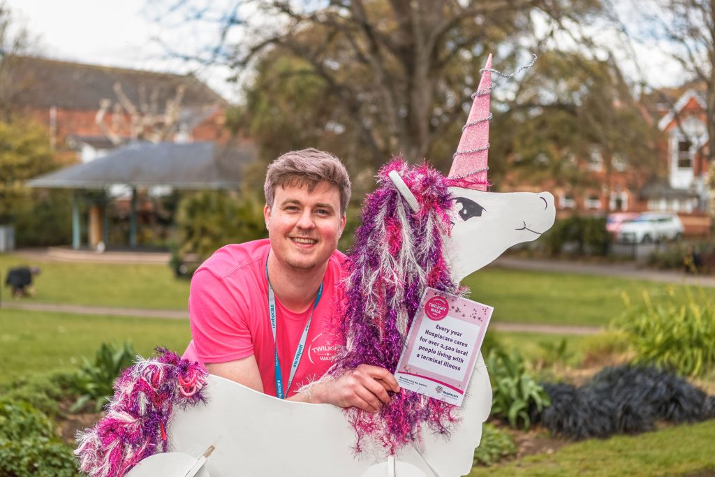 A man in a pink Twilight shirt with a prop unicorn