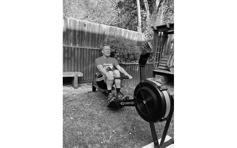 A man on an outdoor rowing machine