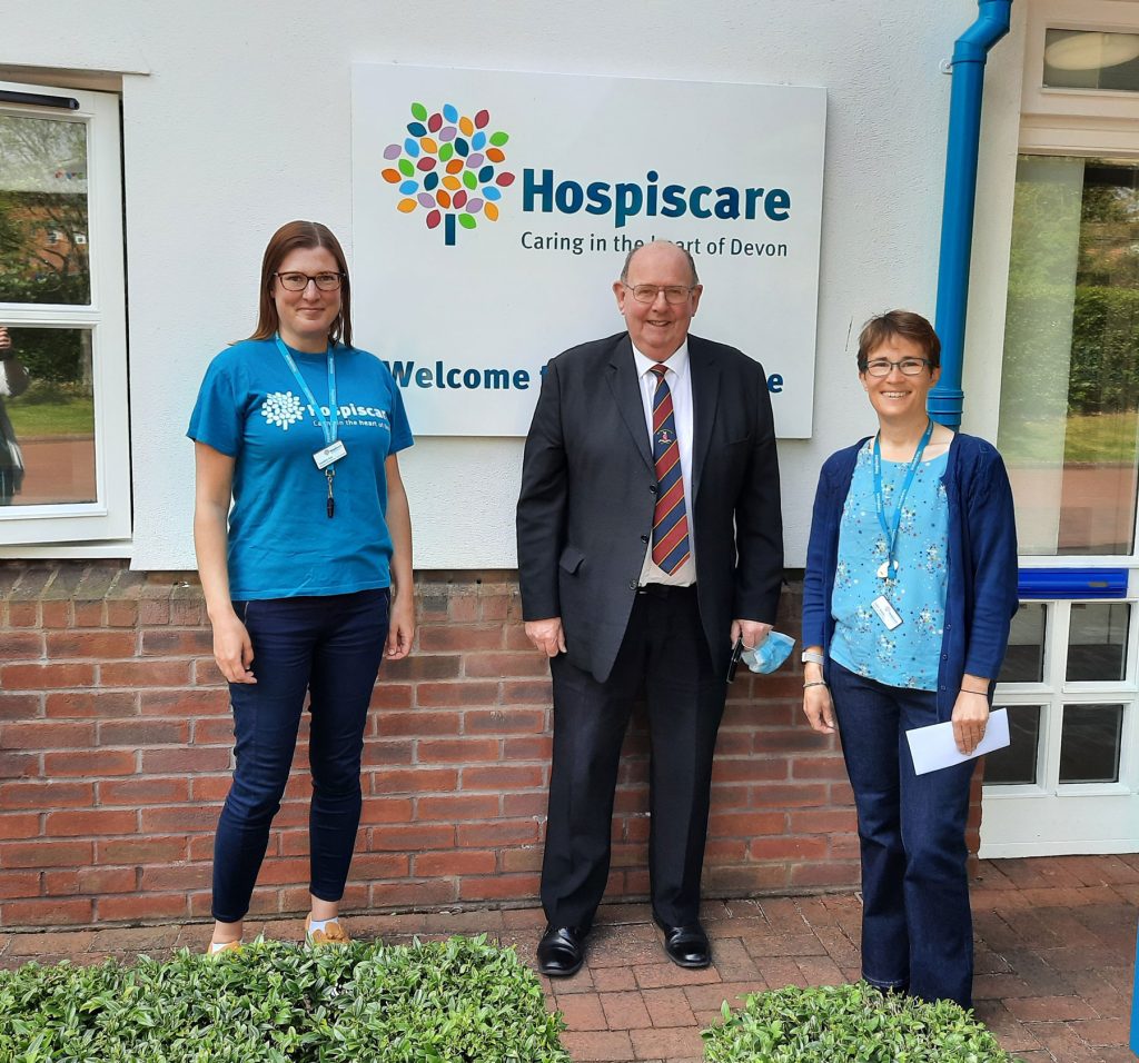Three people stood in front of Hospiscare's main entrance