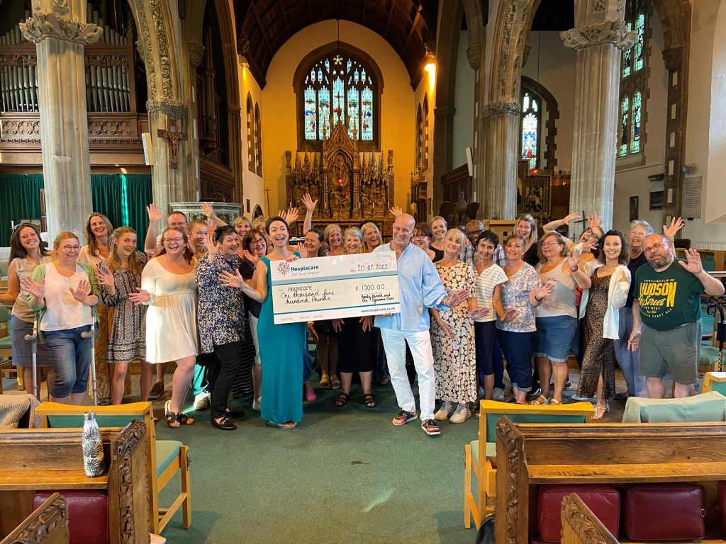 A group of people holding a big cheque in a church