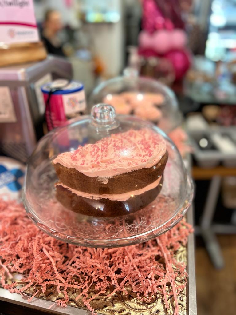 A sponge cake with pink frosting