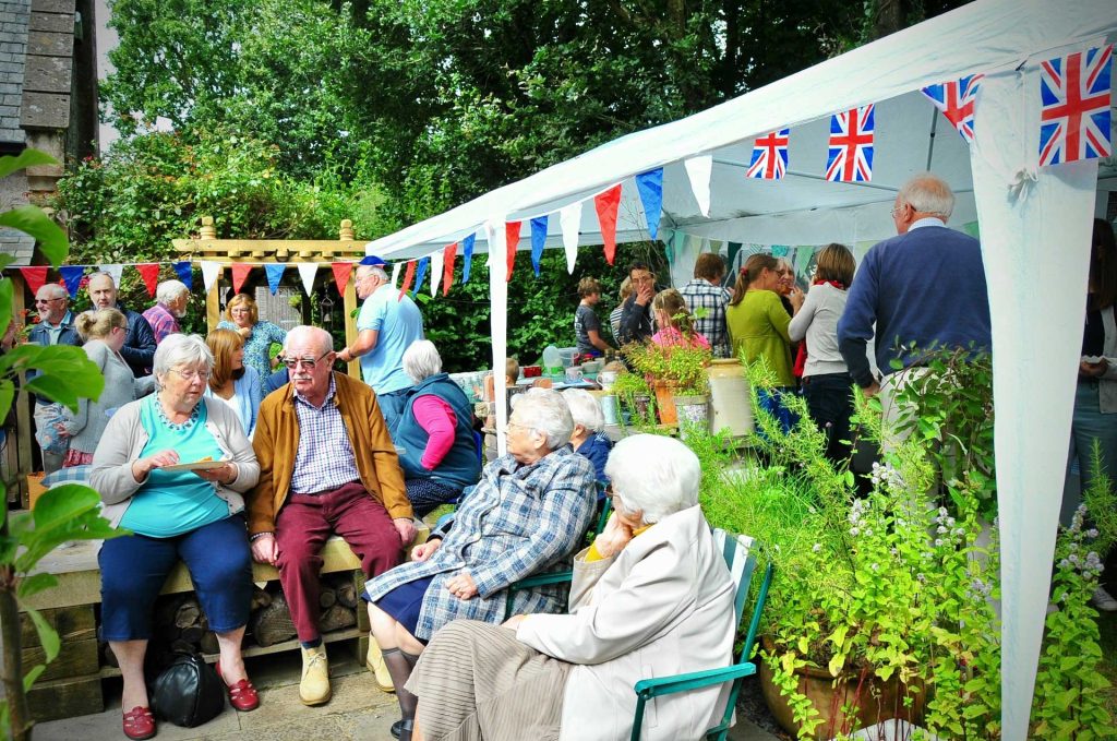 A gathering of people outdoors with bunting