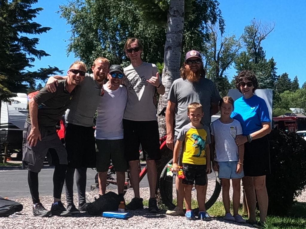 A group of people with arms around each other outside