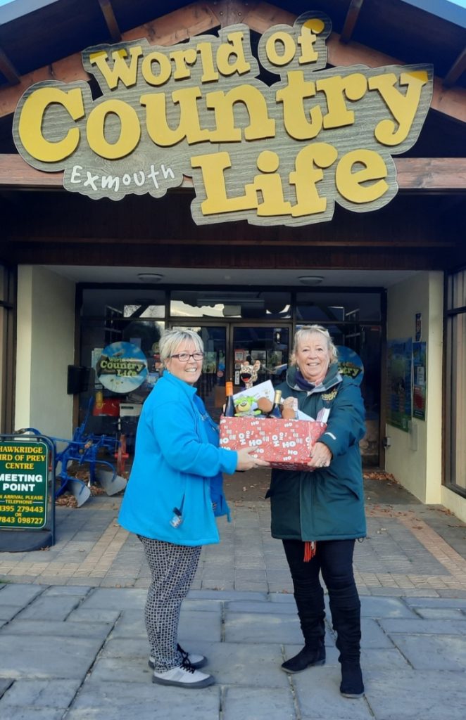 Two women holding a hamper outside World of Country Life